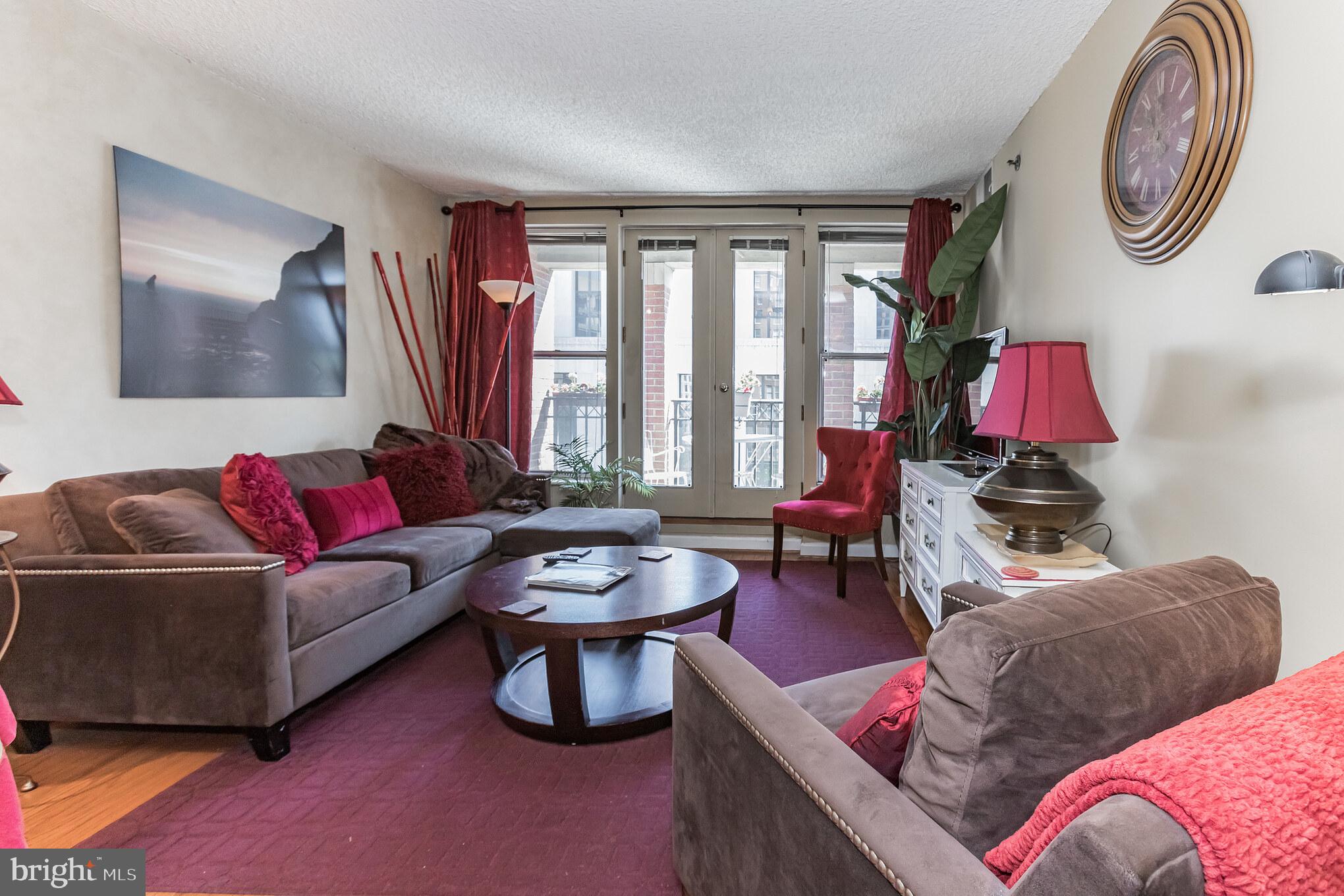 601 Pennsylvania Avenue Northwest, Unit 705 Washington, DC 20004 - Photo 9 of 29 a living room with furniture and a large window