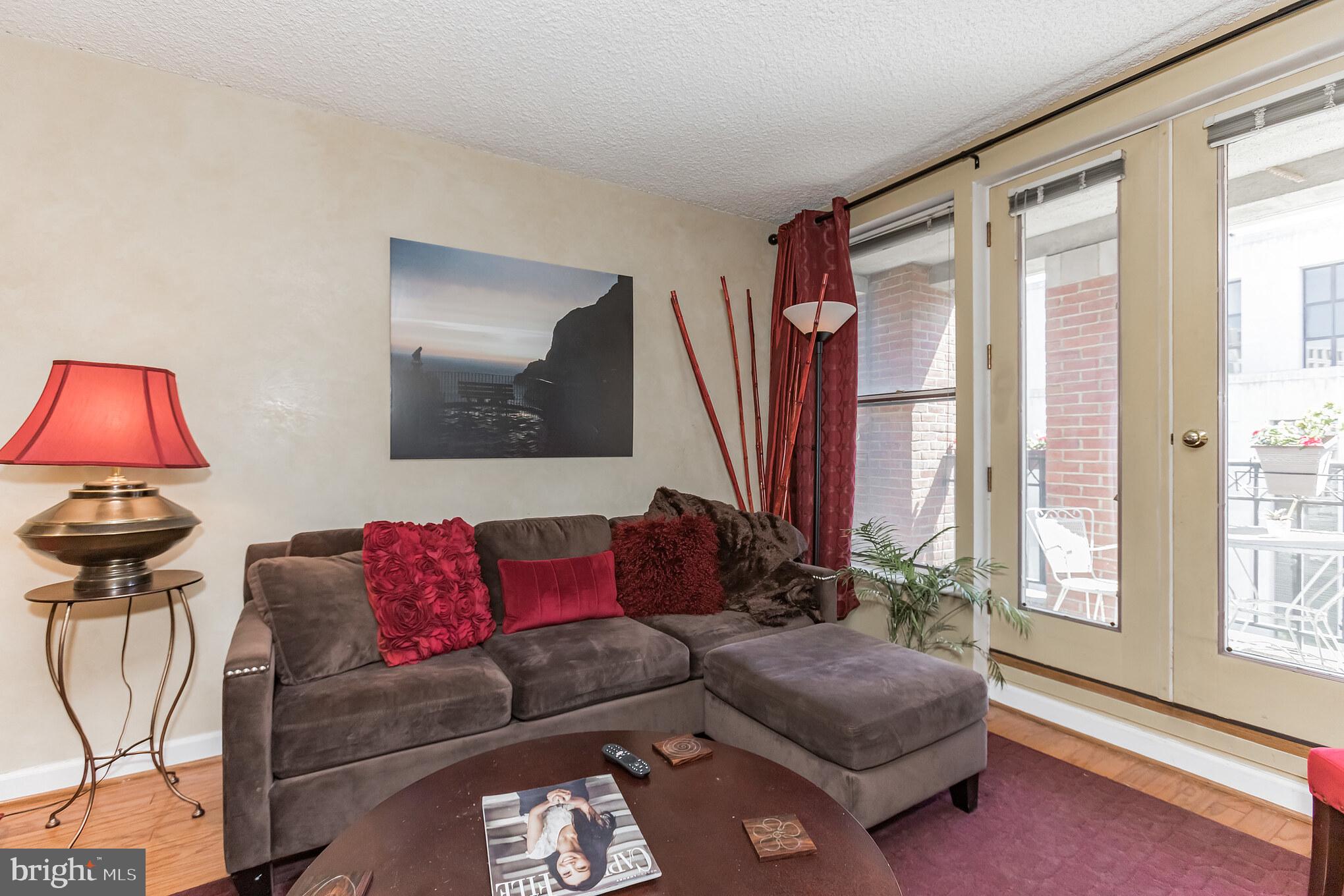601 Pennsylvania Avenue Northwest, Unit 705 Washington, DC 20004 - Photo 10 of 29 a living room with furniture and a window