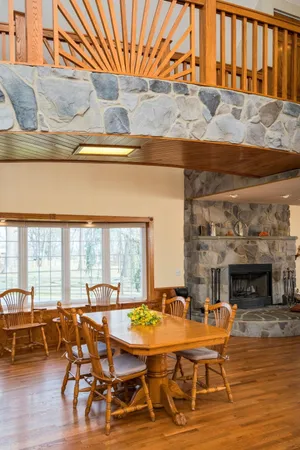 a dining room with lots of furniture and wooden floor