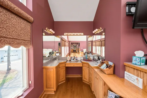 a bedroom with a bed and dresser with mirror