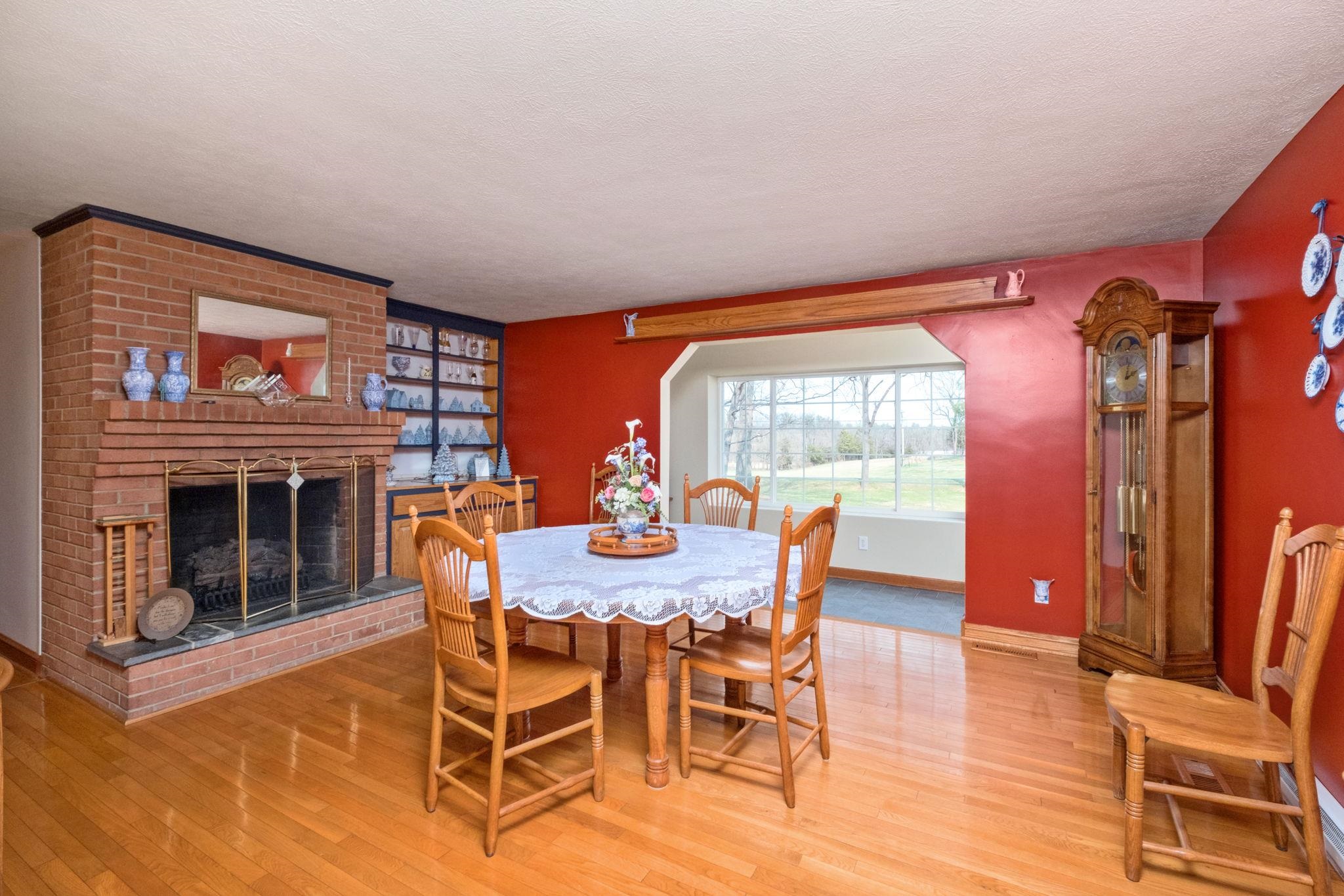 5640 Scotts Ford Road Mount Crawford, VA 22841 - Photo 35 of 68 a dining room with furniture a fireplace and wooden floor