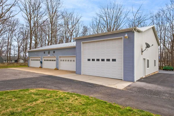 a view of a house with a yard and garage