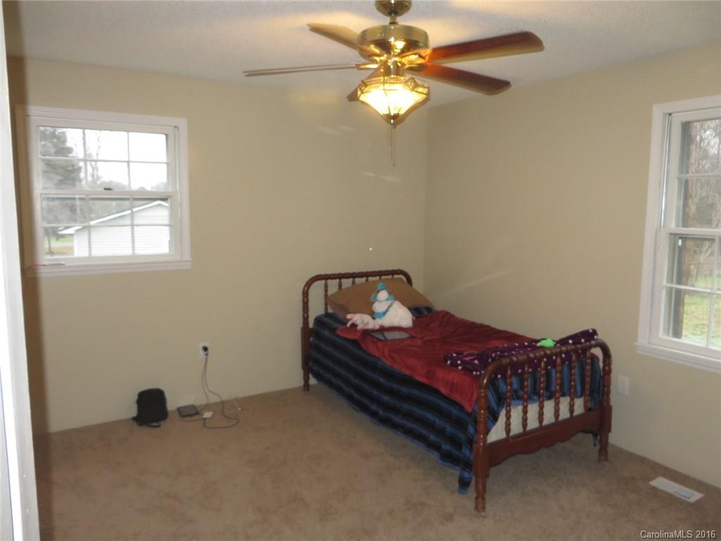536 Blacksnake Road Stanley, NC 28164 - Photo 11 of 14 a bed sitting in a bedroom next to a window