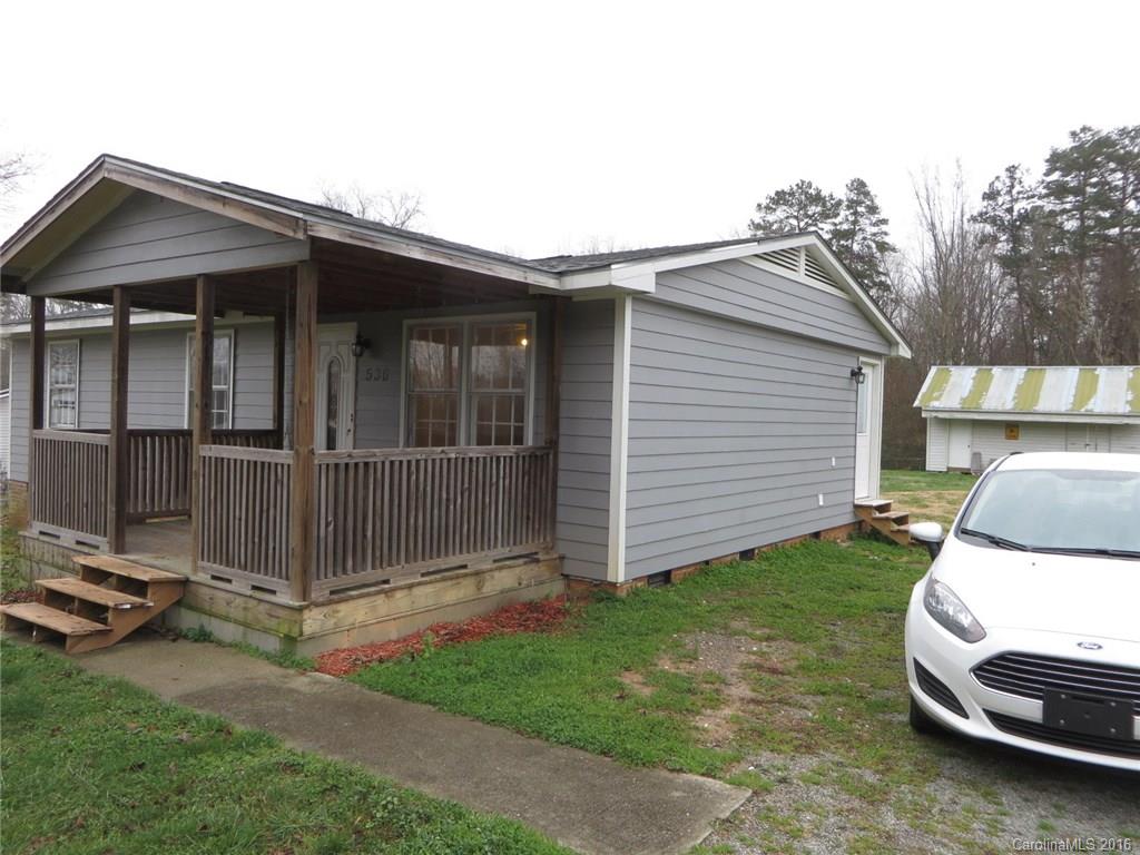 536 Blacksnake Road Stanley, NC 28164 - Photo 14 of 14 a white house that has a small yard and large trees