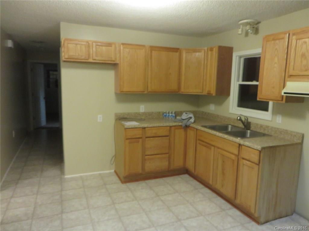 536 Blacksnake Road Stanley, NC 28164 - Photo 6 of 14 a kitchen with a sink window and cabinets