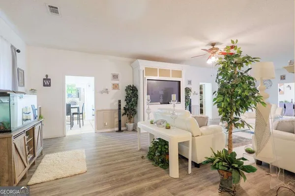 a living room with furniture and a potted plant