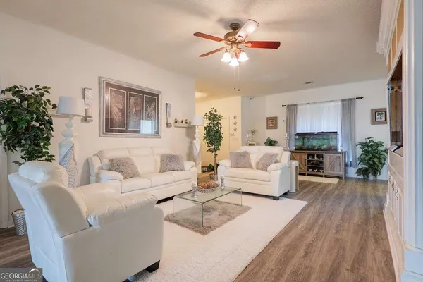 a living room with furniture and a chandelier