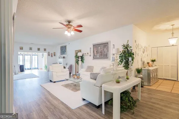 a living room with furniture and wooden floor