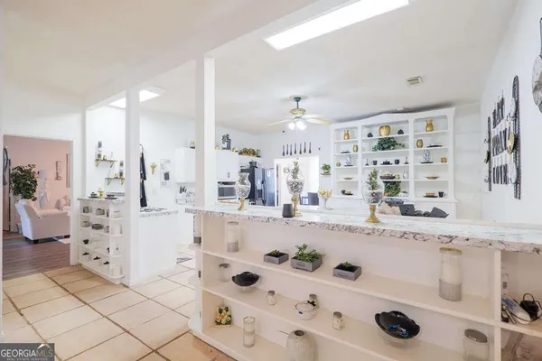 a bathroom with a granite countertop sink mirror and shower