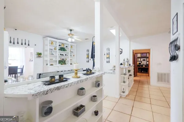 a bathroom with a granite countertop sink a mirror and shower