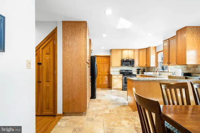 a kitchen that has a sink and a stove in it
