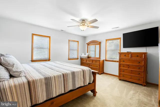 a view of a lake with lawn chairs