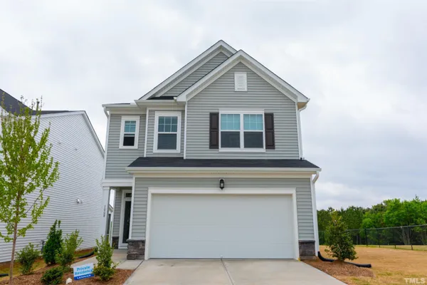 a front view of a house with garage