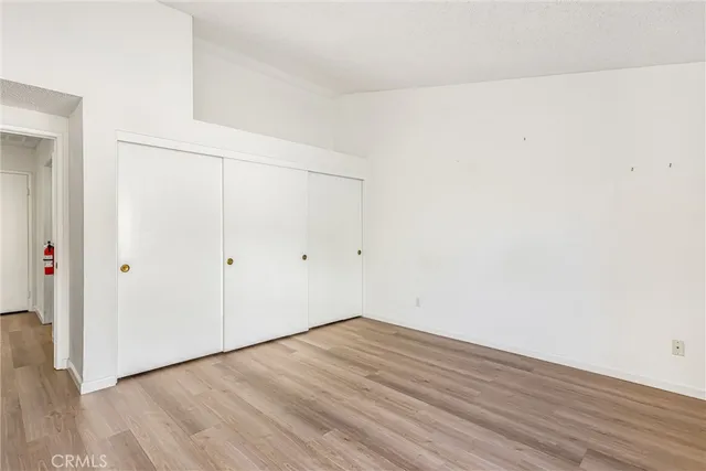 a view of a room with wooden floor and furniture