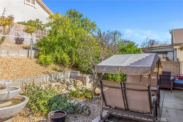 a view of a patio with table and chairs and potted plants