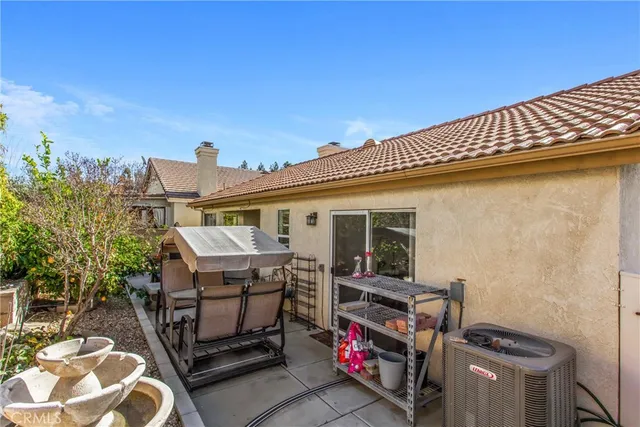 a view of a patio with table and chairs and potted plants