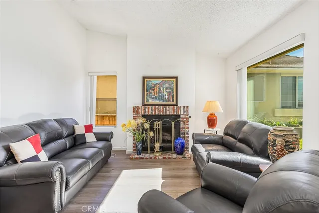 a living room with furniture fireplace and a window