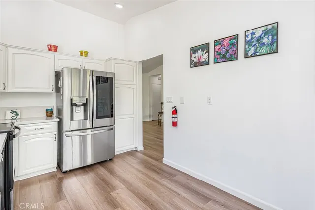 a kitchen with stainless steel appliances a refrigerator and a stove top oven