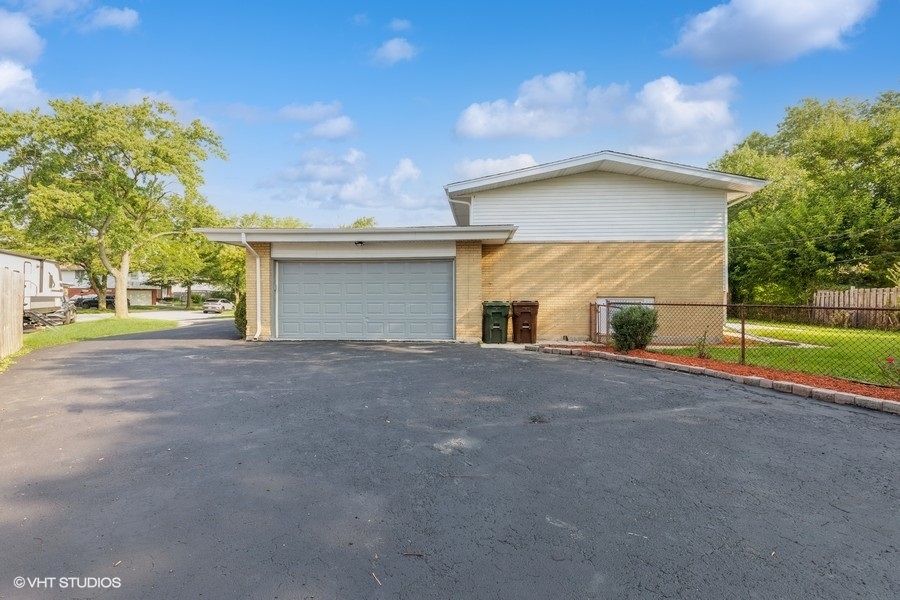 18849 Jamie Court Homewood, IL 60430 - Photo 21 of 25 a view of a house with a yard and garage