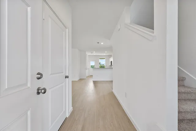 a view of a hallway with wooden floor