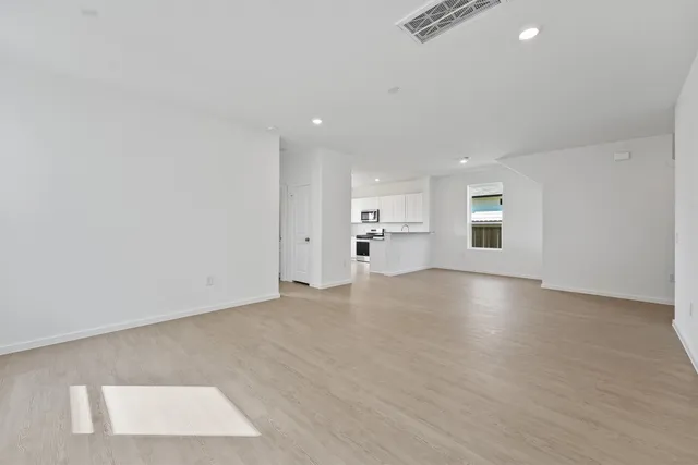 an empty room with windows and entrance