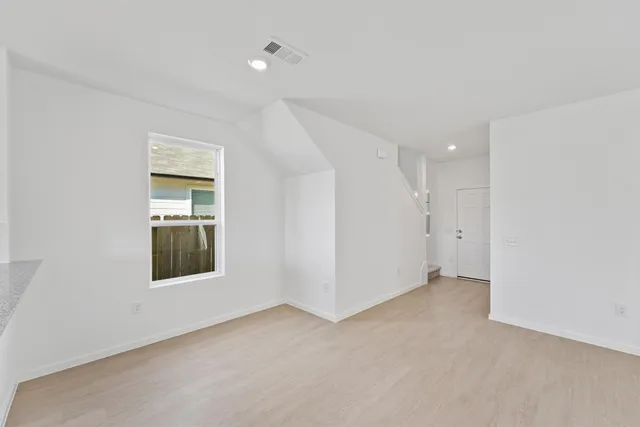 an empty room with windows and closet