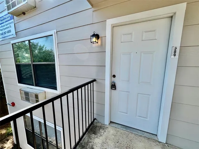 a view of a hallway with wooden floor and entryway