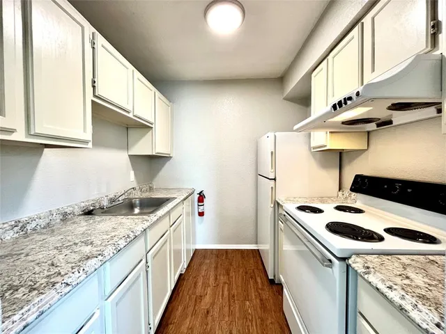 a kitchen with a stove and a sink