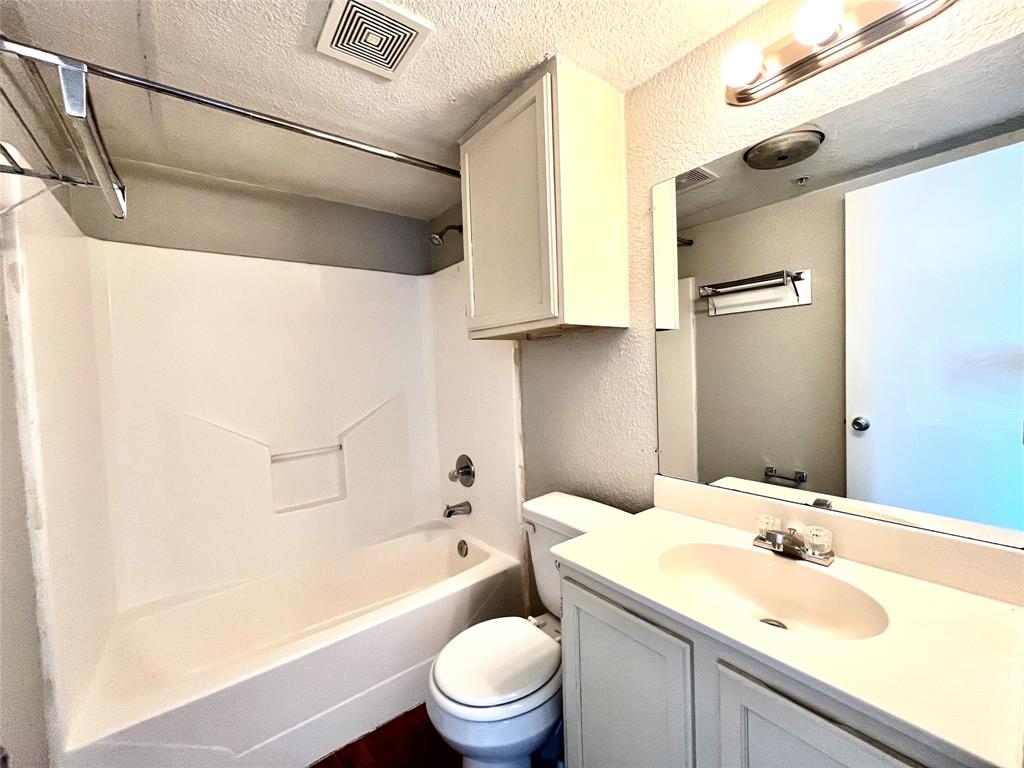 701 West Sycamore Street, Unit 209 Denton, TX 76201 - Photo 6 of 10 a bathroom with a granite countertop sink toilet and shower