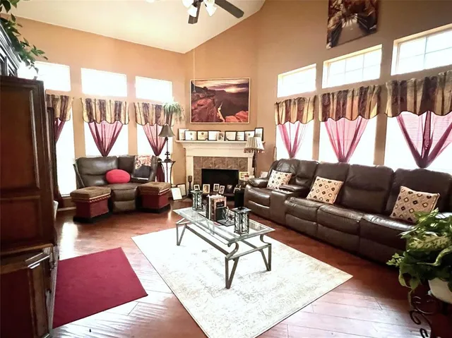 a living room with furniture a fireplace and a large window