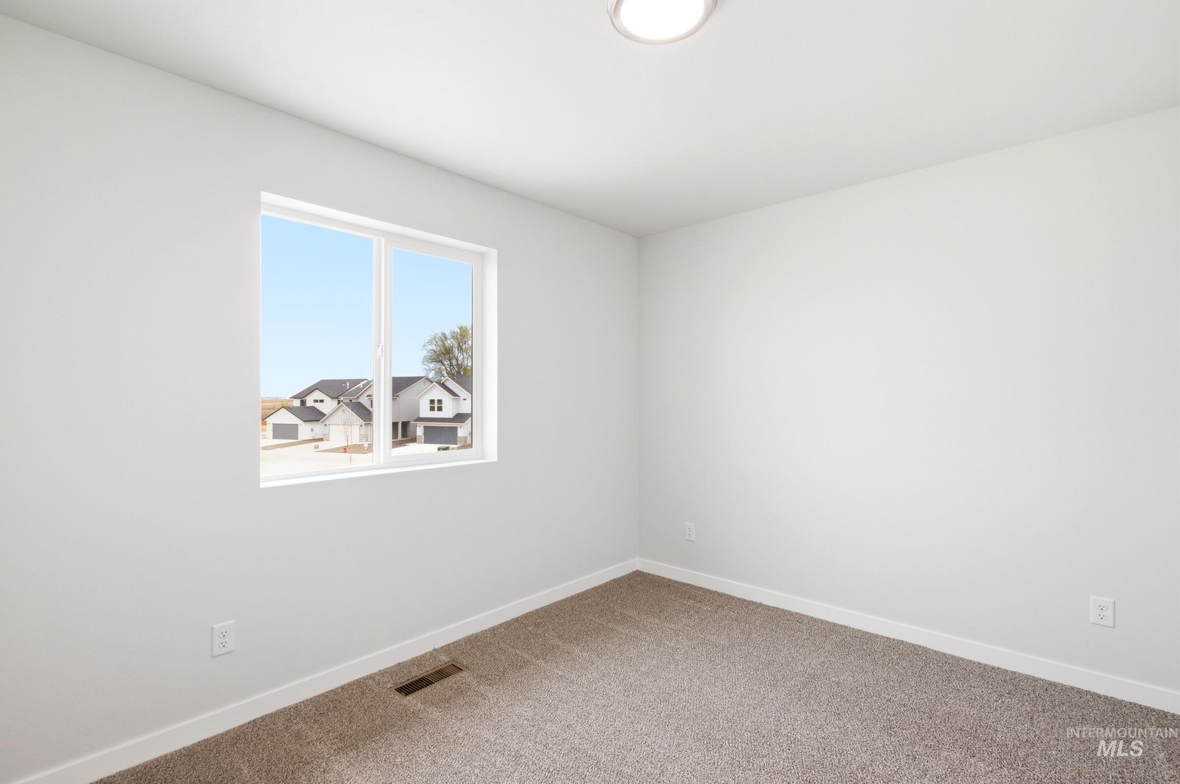 10776 Rutland Street Caldwell, ID 83605 - Photo 13 of 22 Unfurnished room featuring baseboards and light colored carpet