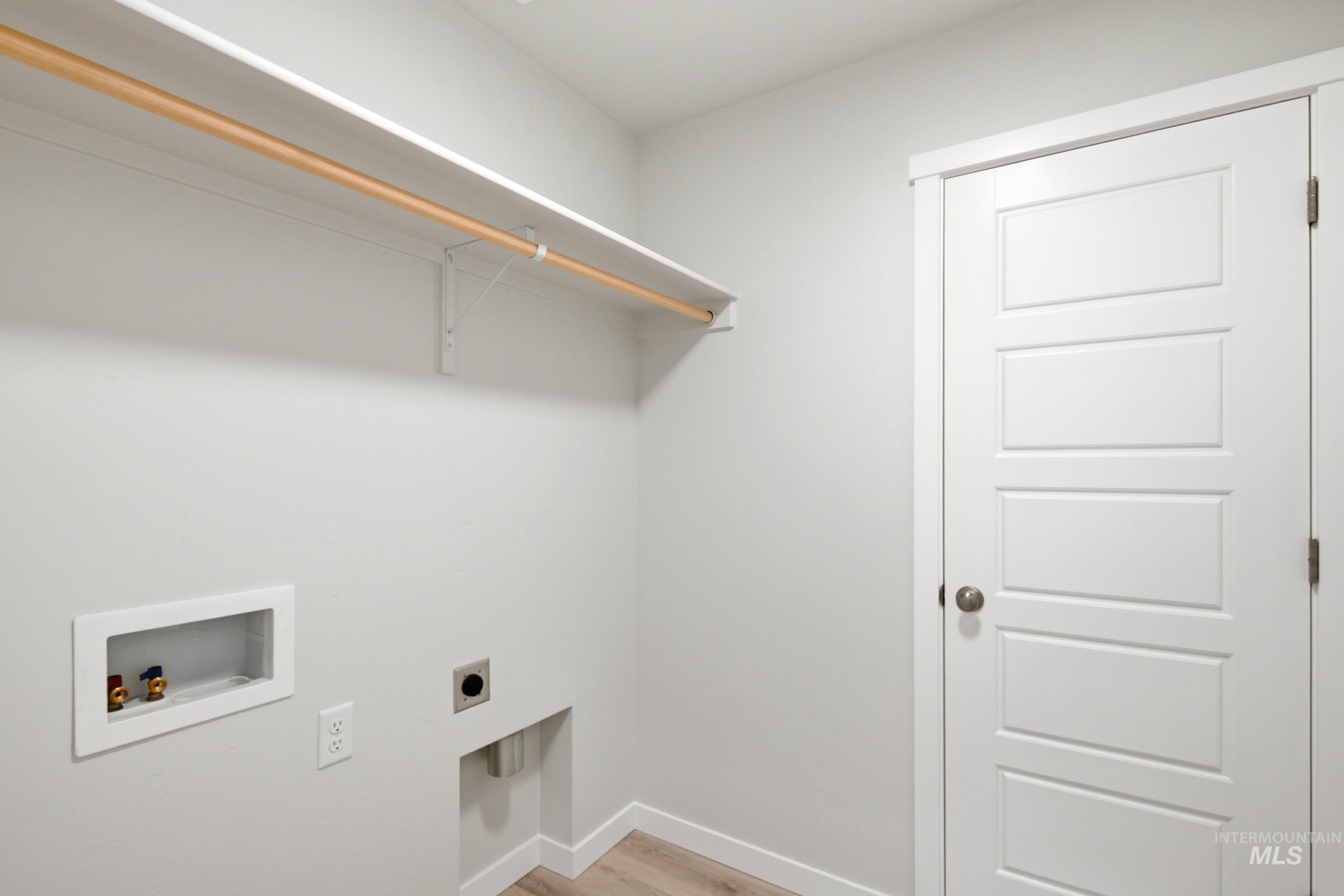 10776 Rutland Street Caldwell, ID 83605 - Photo 15 of 22 Laundry area with washer hookup, light wood finished floors, and electric dryer hookup