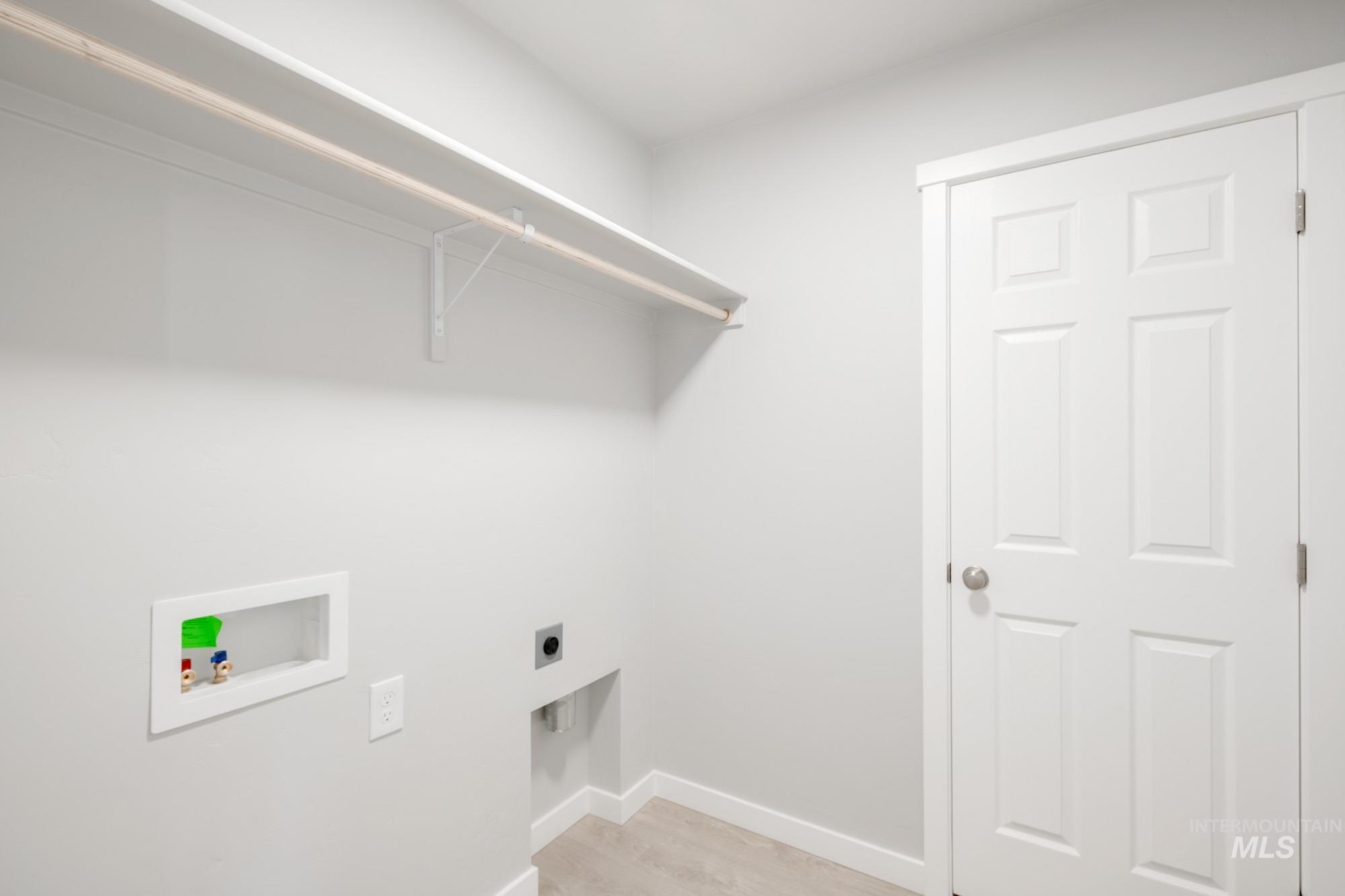 10776 Rutland Street Caldwell, ID 83605 - Photo 15 of 22 Laundry room featuring light wood finished floors, hookup for a washing machine, and electric dryer hookup