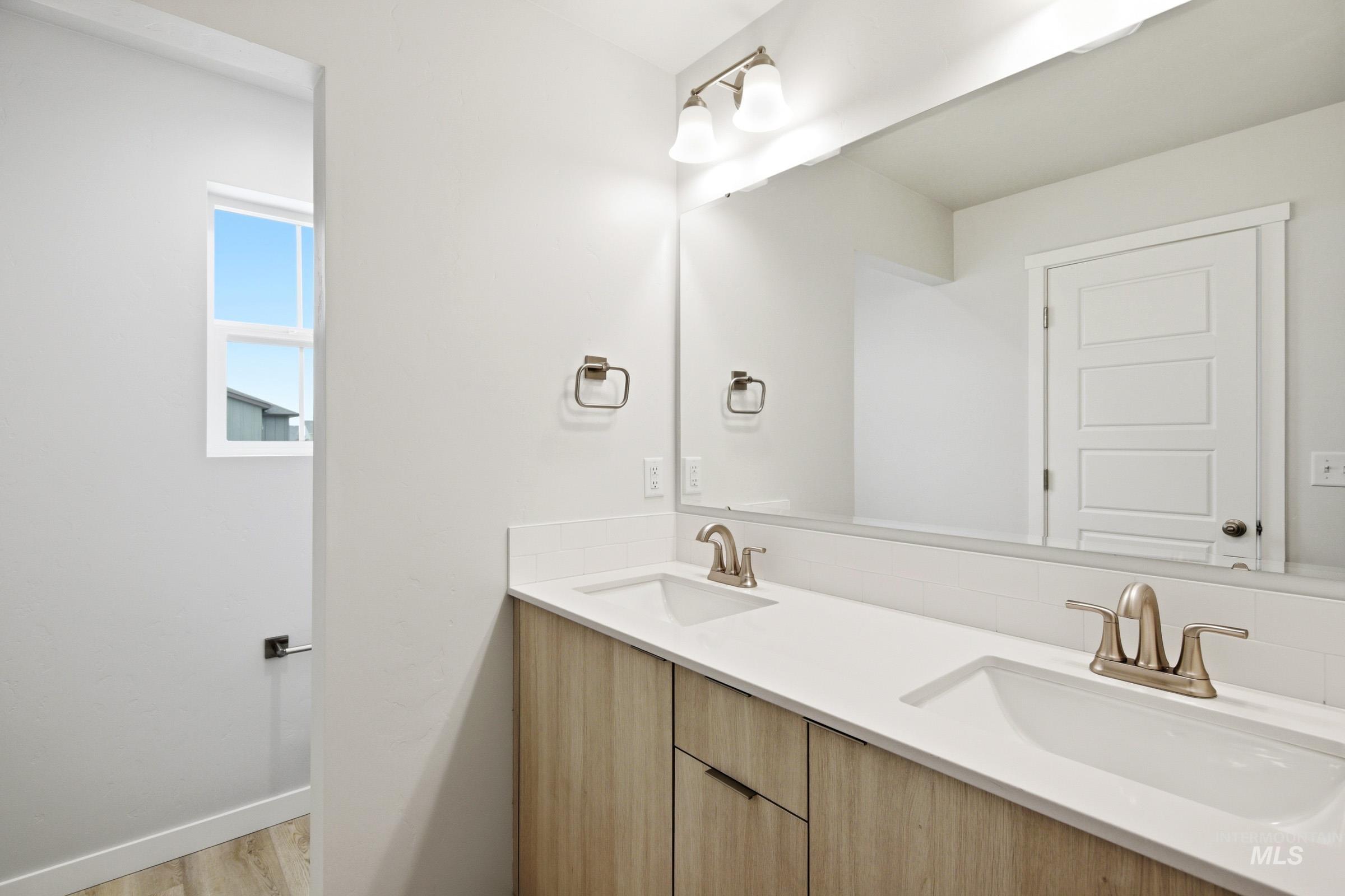 10776 Rutland Street Caldwell, ID 83605 - Photo 18 of 22 Bathroom with double vanity and light wood-style flooring