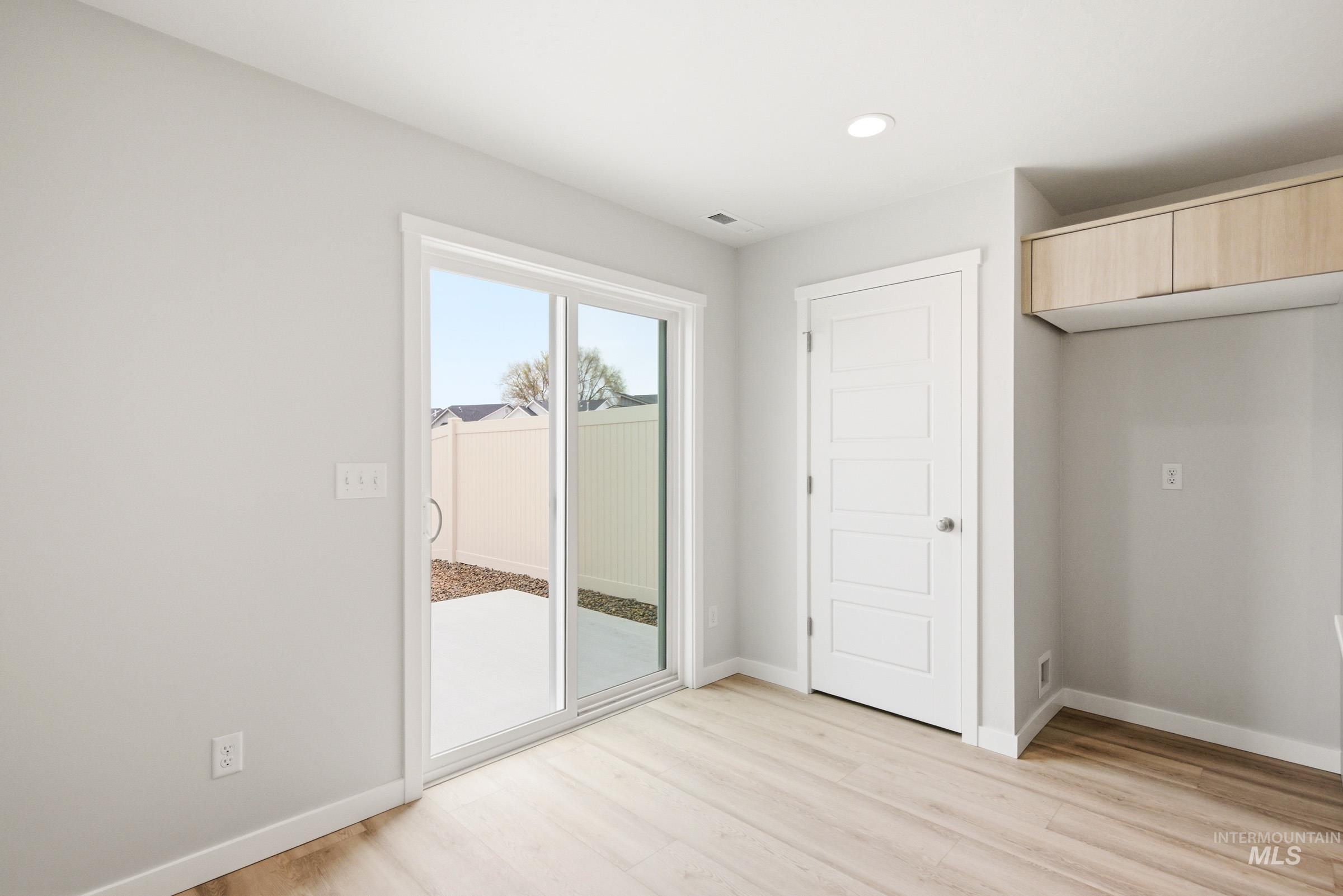 10776 Rutland Street Caldwell, ID 83605 - Photo 9 of 22 Unfurnished bedroom with access to outside, light wood-style floors, and recessed lighting
