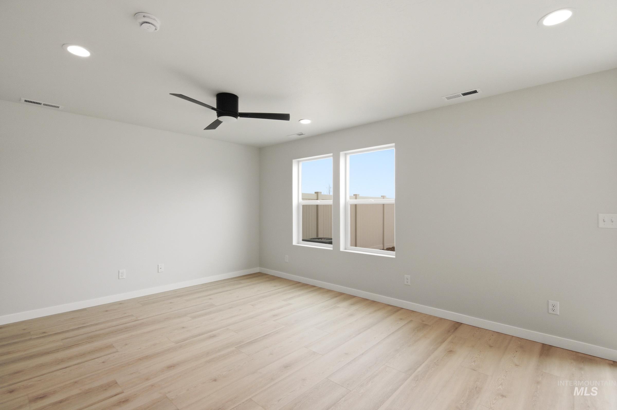 10776 Rutland Street Caldwell, ID 83605 - Photo 10 of 22 Empty room with light wood-type flooring, recessed lighting, and a ceiling fan