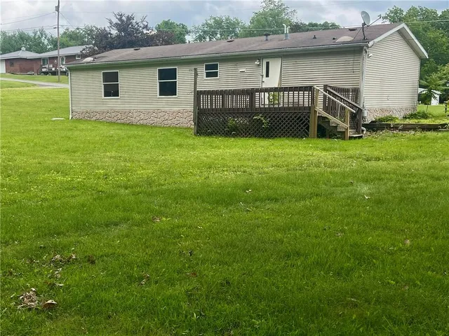 a view of a house with a yard and a porch