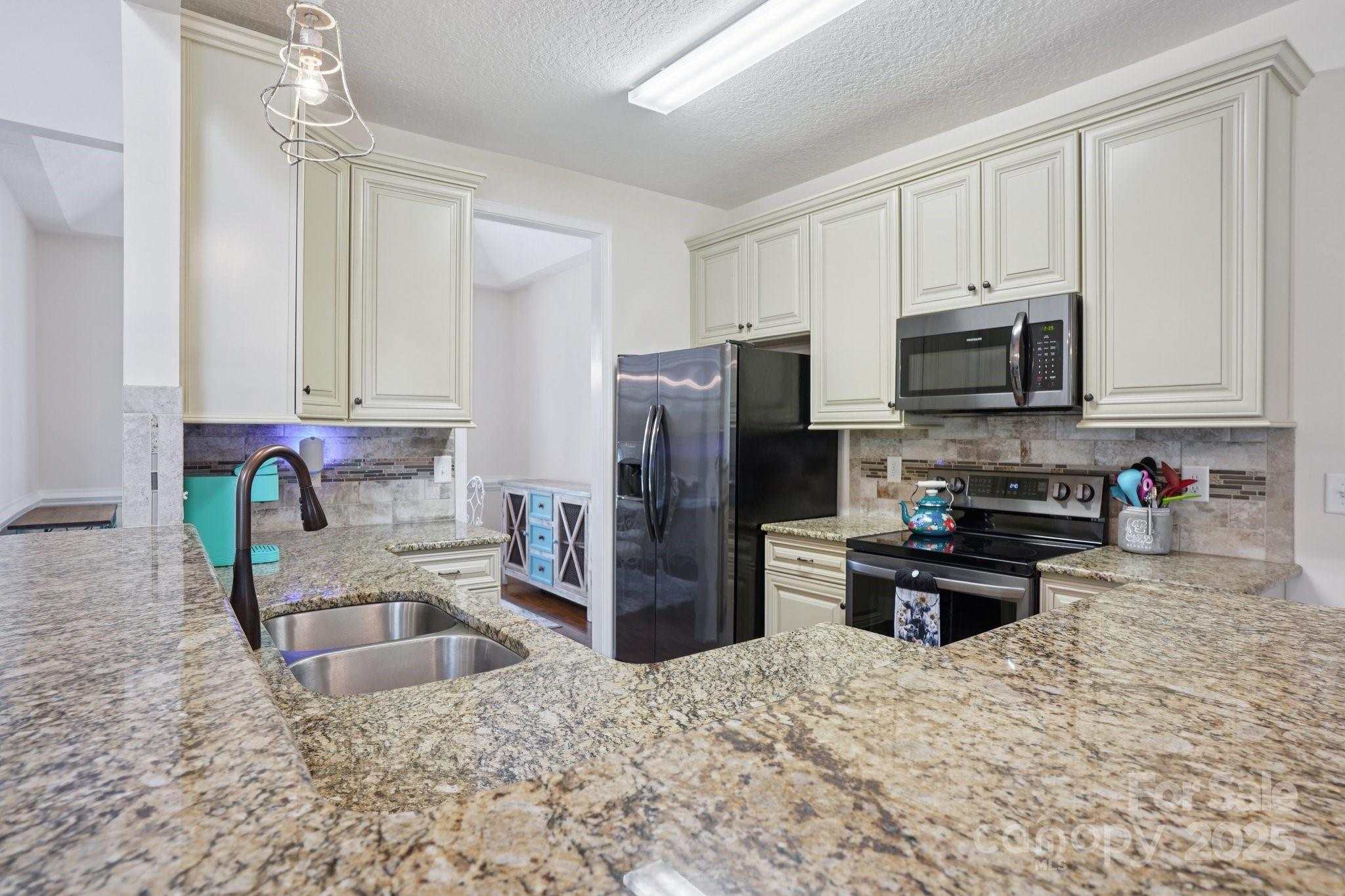 2209 Cedar Road York, SC 29745 - Photo 13 of 48 a kitchen with stainless steel appliances granite countertop a refrigerator sink and stove