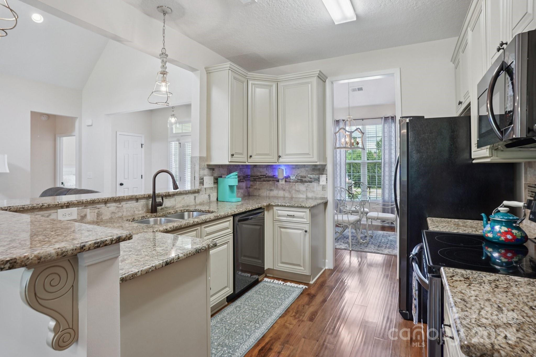 2209 Cedar Road York, SC 29745 - Photo 15 of 48 a kitchen with stainless steel appliances granite countertop a sink stove and refrigerator