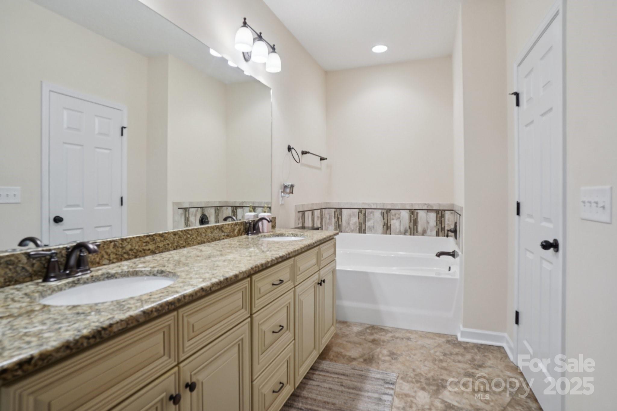 2209 Cedar Road York, SC 29745 - Photo 29 of 48 a spacious bathroom with a granite countertop sink mirror and a bathtub