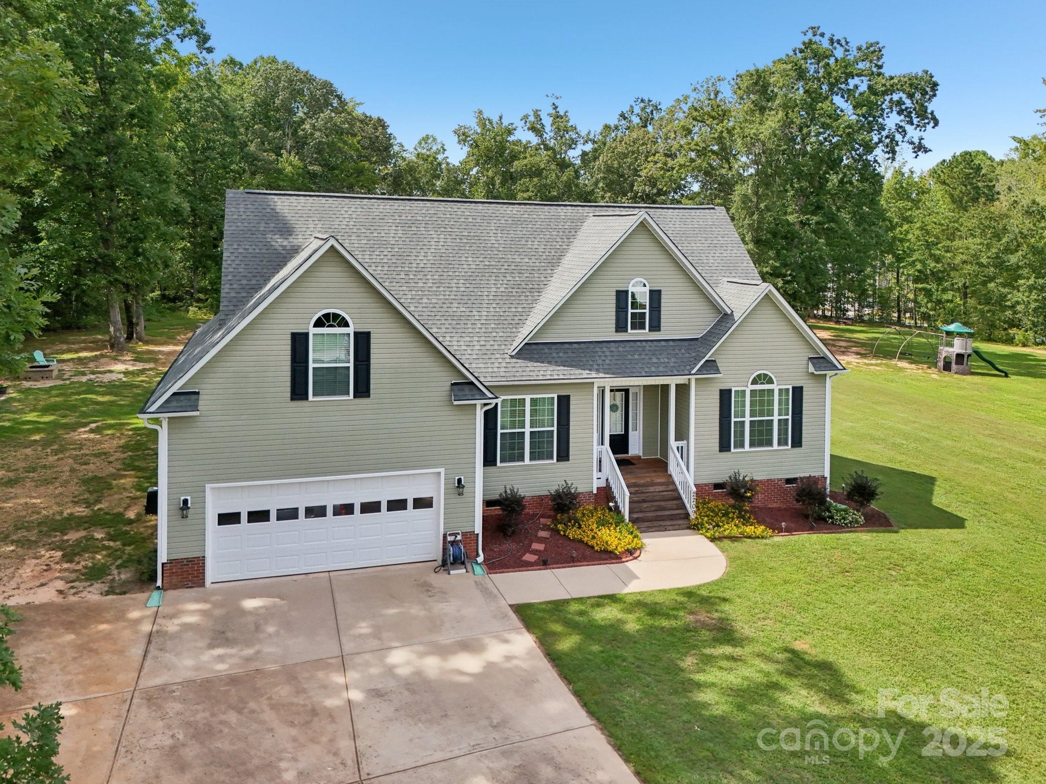 2209 Cedar Road York, SC 29745 - Photo 43 of 48 a view of a house with a yard potted plants and a bench