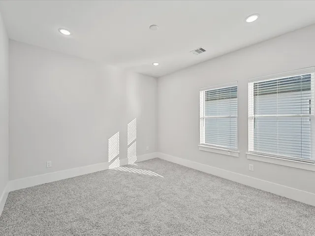 an empty room with a empty space and windows