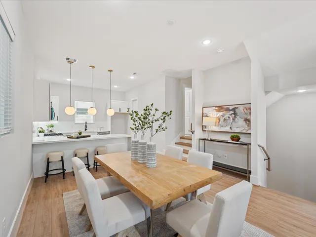 a dining room with furniture and wooden floor