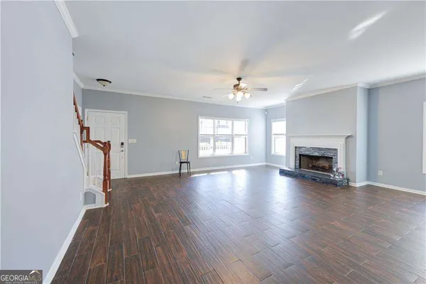 an empty room with wooden floor and fireplace