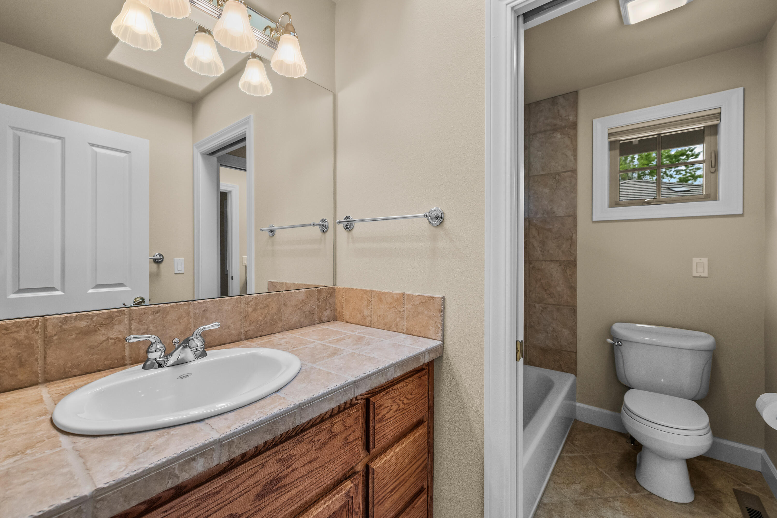 19598 Green Lakes Loop Bend, OR 97702 - Photo 40 of 89 a bathroom with a granite countertop sink and a mirror
