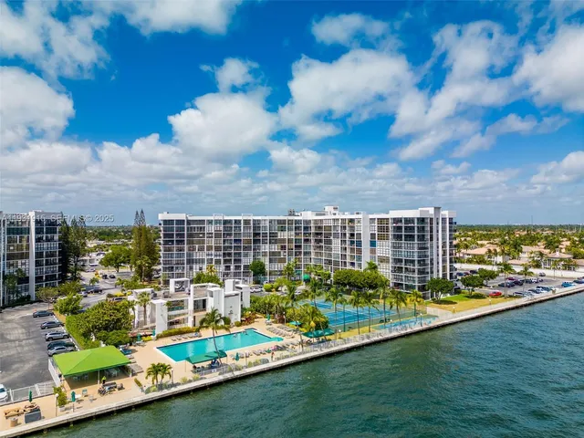 a view of a city with tall buildings and a big yard