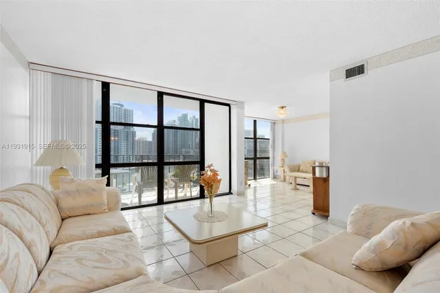a living room with furniture and a large window