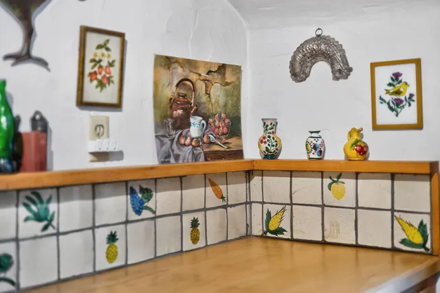 a view of staircase with a lots of frames on the wall