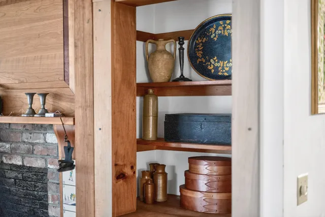 a living room with a fireplace and a painting on the wall