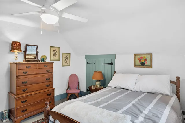 a bedroom with a bed and a dresser